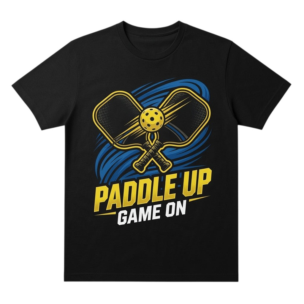TrendyShift.Com black cotton t-shirt featuring a yellow pickleball paddle graphic with the text Paddle Up Game On.
