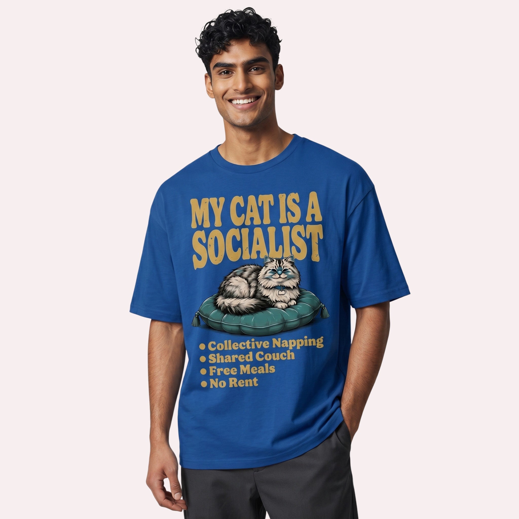 TrendyShift.Com blue cotton graphic tee featuring a cat illustration and My Cat Is a Socialist text on a male model