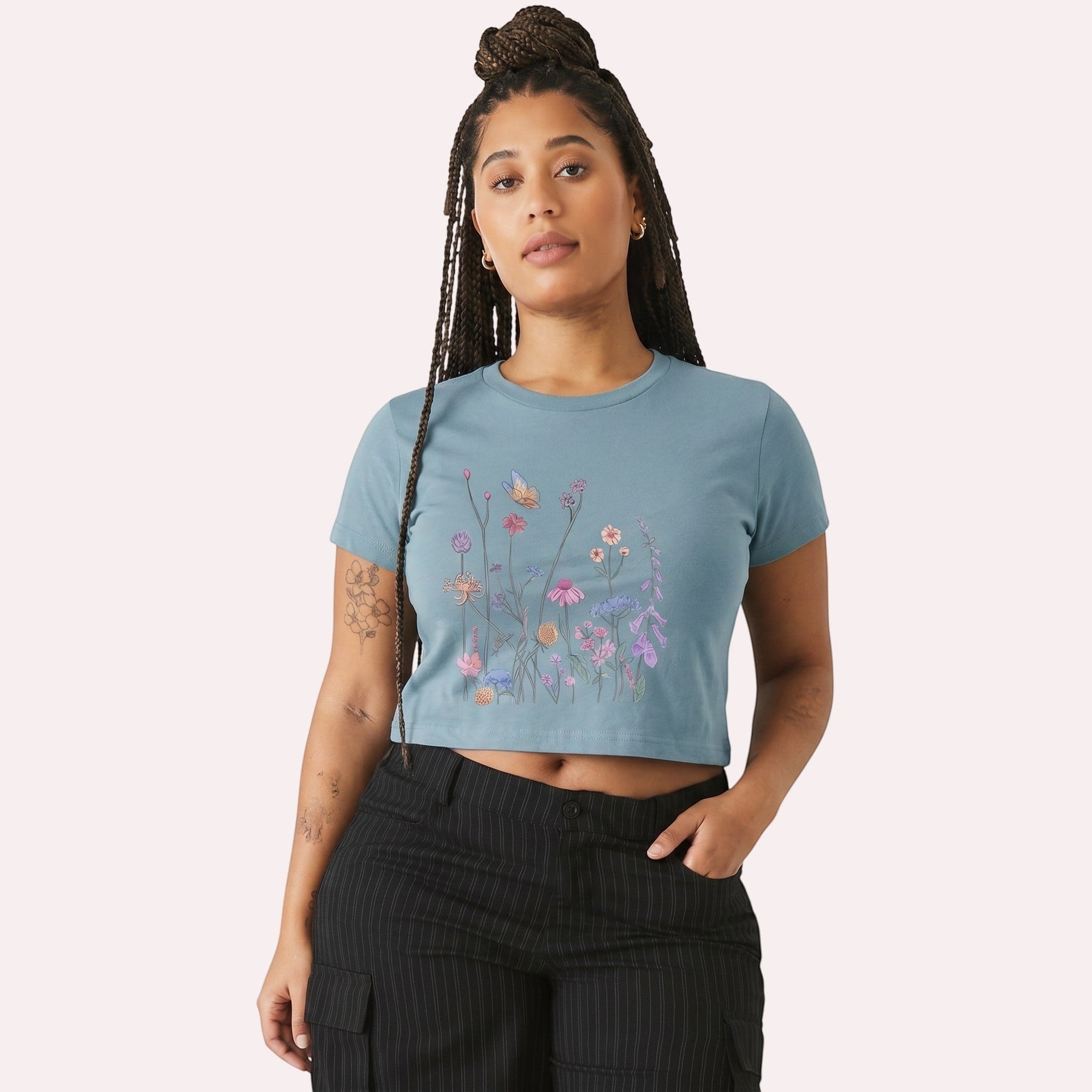 TrendyShift.Com women's blue micro rib crop tee featuring a colorful wildflower and butterfly graphic print.