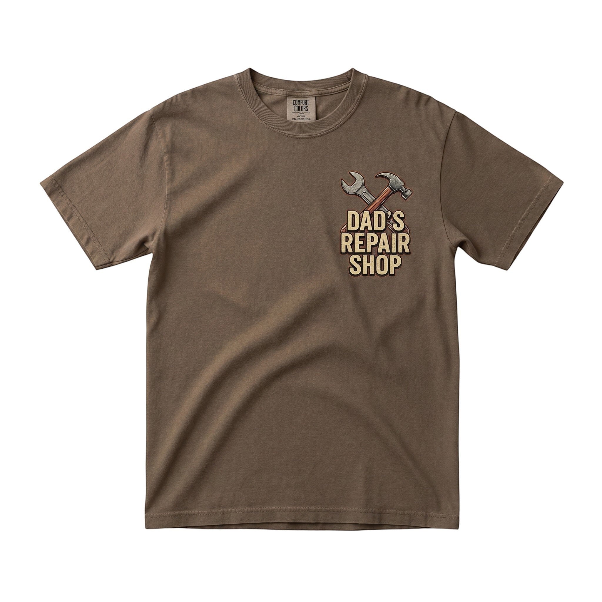 TrendyShift.Com brown short sleeve crew neck t-shirt with Dad's Repair Shop hammer and wrench graphic on the chest