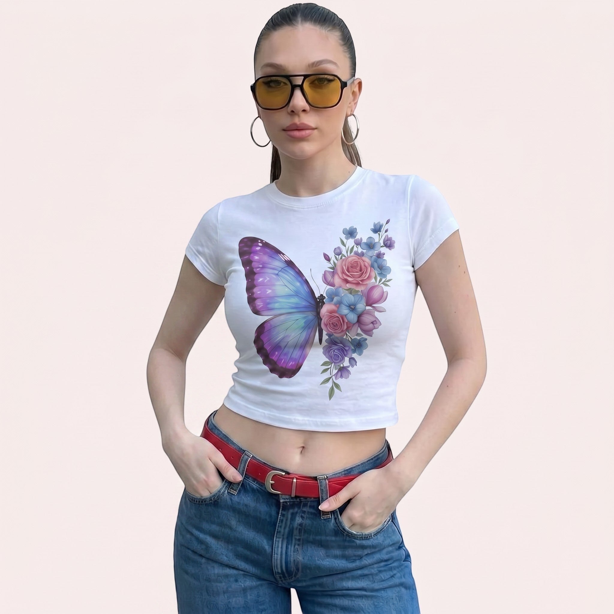 TrendyShift.Com white micro rib baby tee featuring a pastel butterfly and floral print worn by a woman in sunglasses.