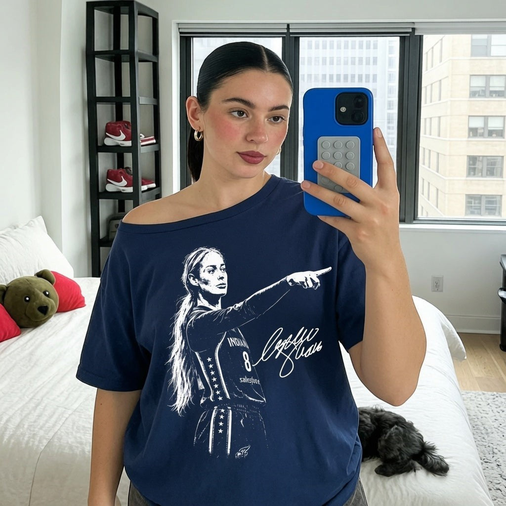 TrendyShift.Com navy blue off-the-shoulder t-shirt featuring a graphic of a female basketball player pointing