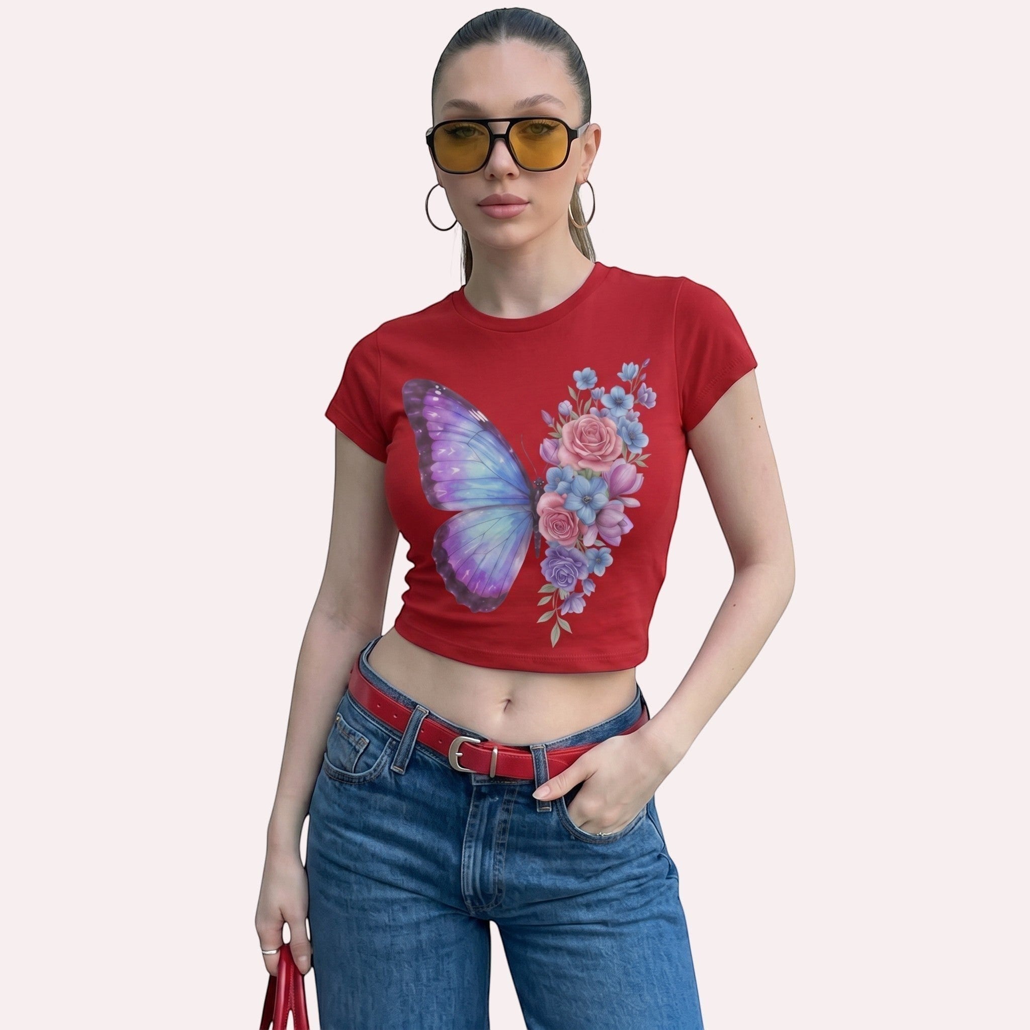 TrendyShift.Com red micro rib baby tee with butterfly and floral graphic, worn by a model with sunglasses and jeans.