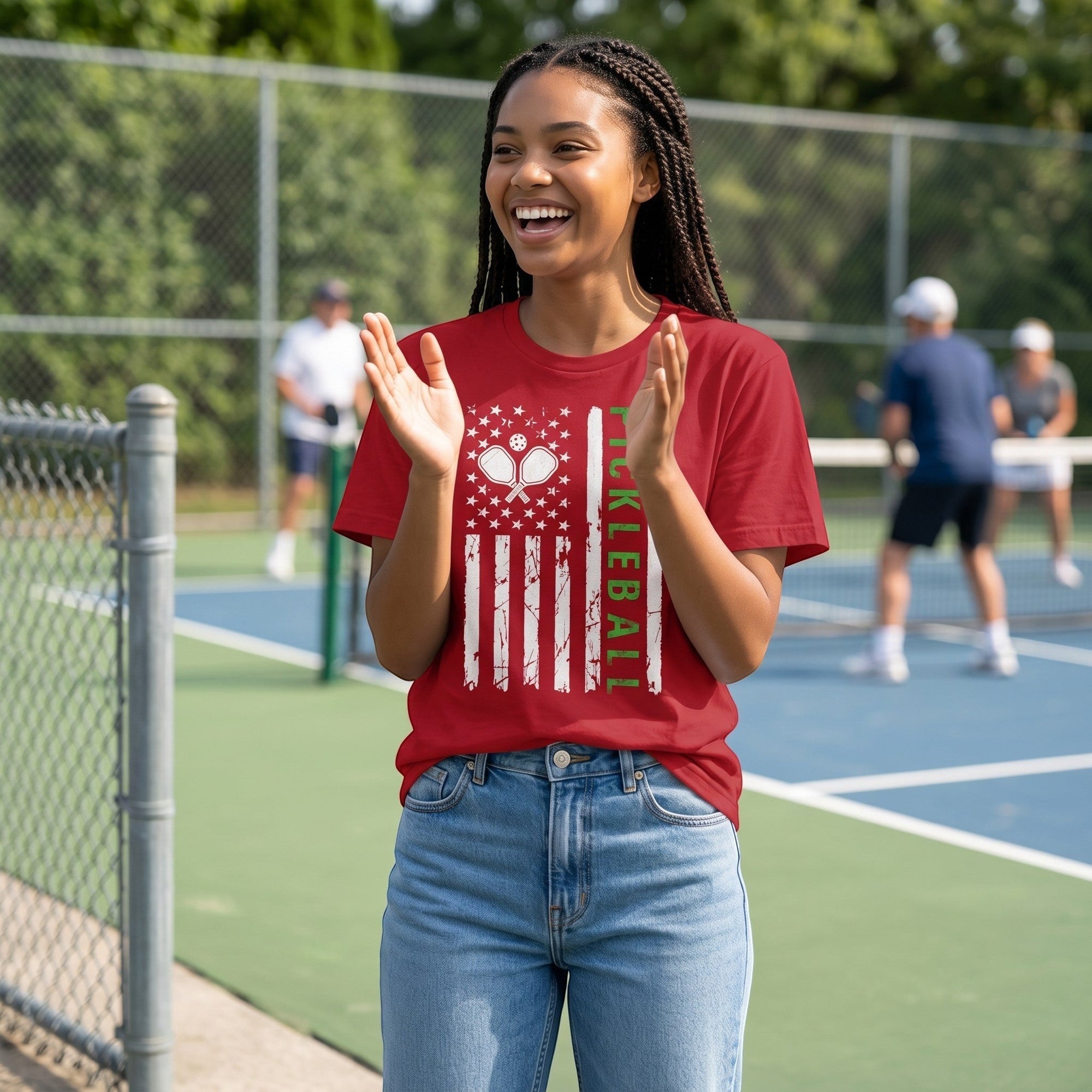 TrendyShift.Com red pickleball jersey tee with American flag graphic on a woman at a pickleball court