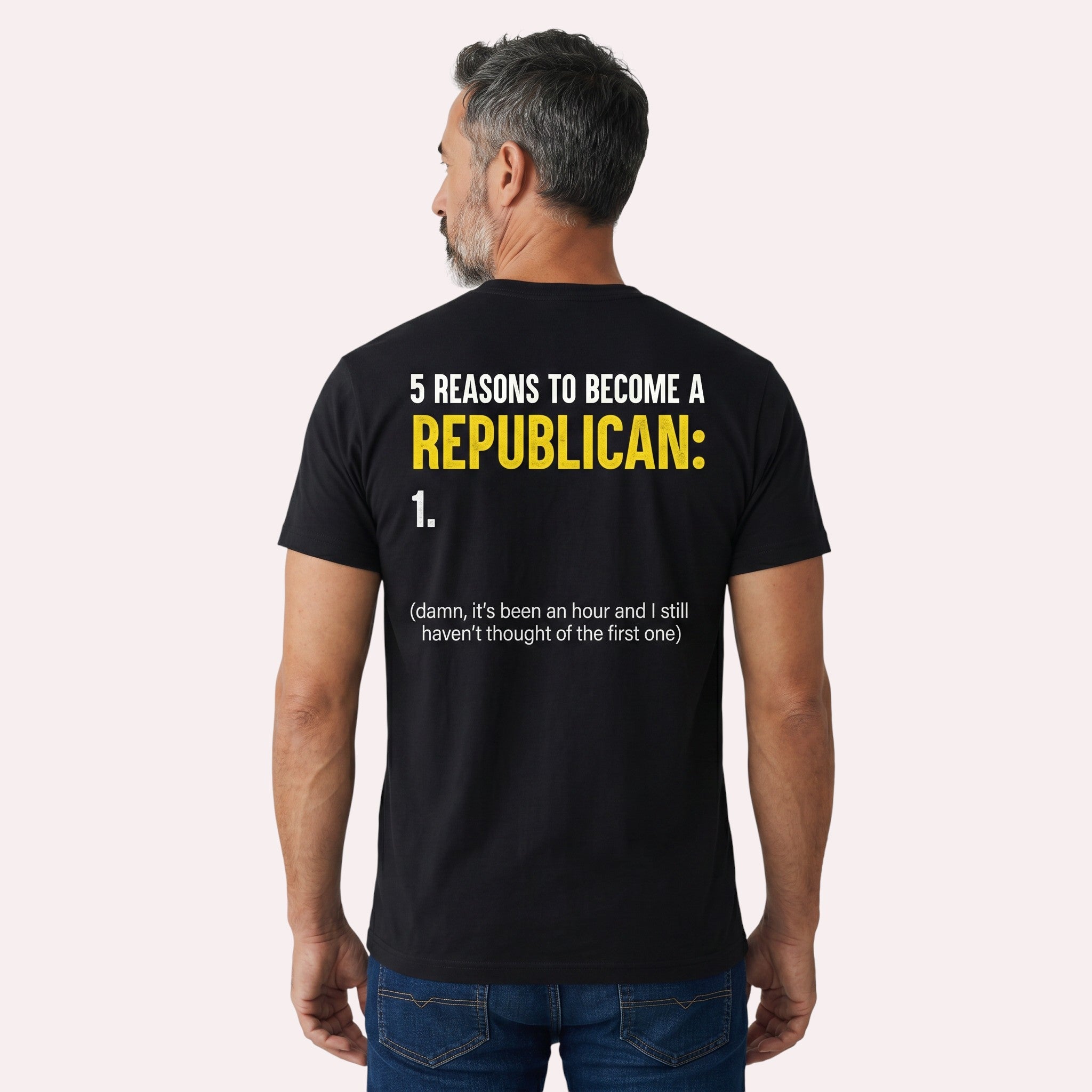 TrendyShift.Com black cotton t-shirt with satirical political humor text on the back, worn by a man from behind.