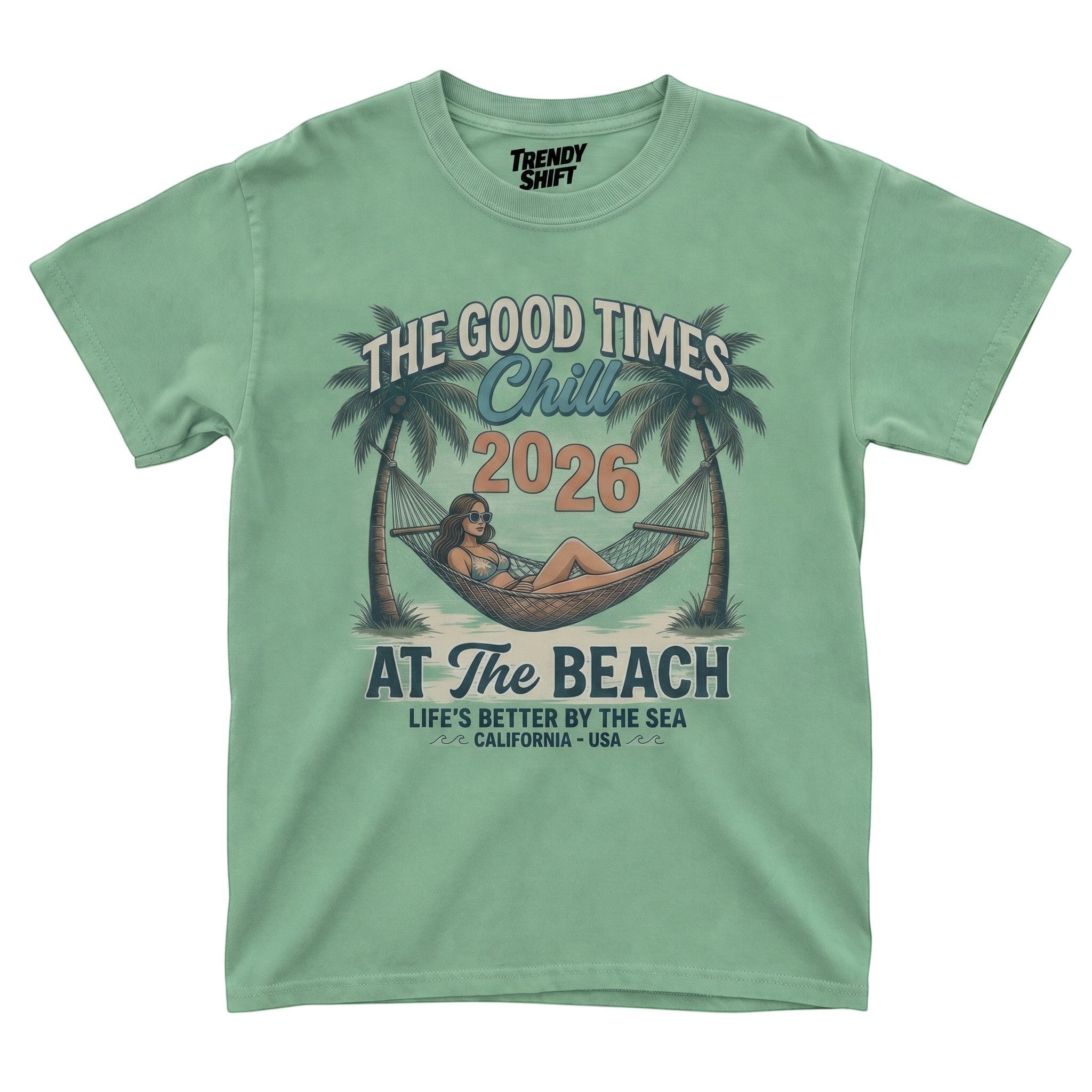 TrendyShift.Com sage green graphic t-shirt featuring a woman in a hammock between palm trees with retro beach text.