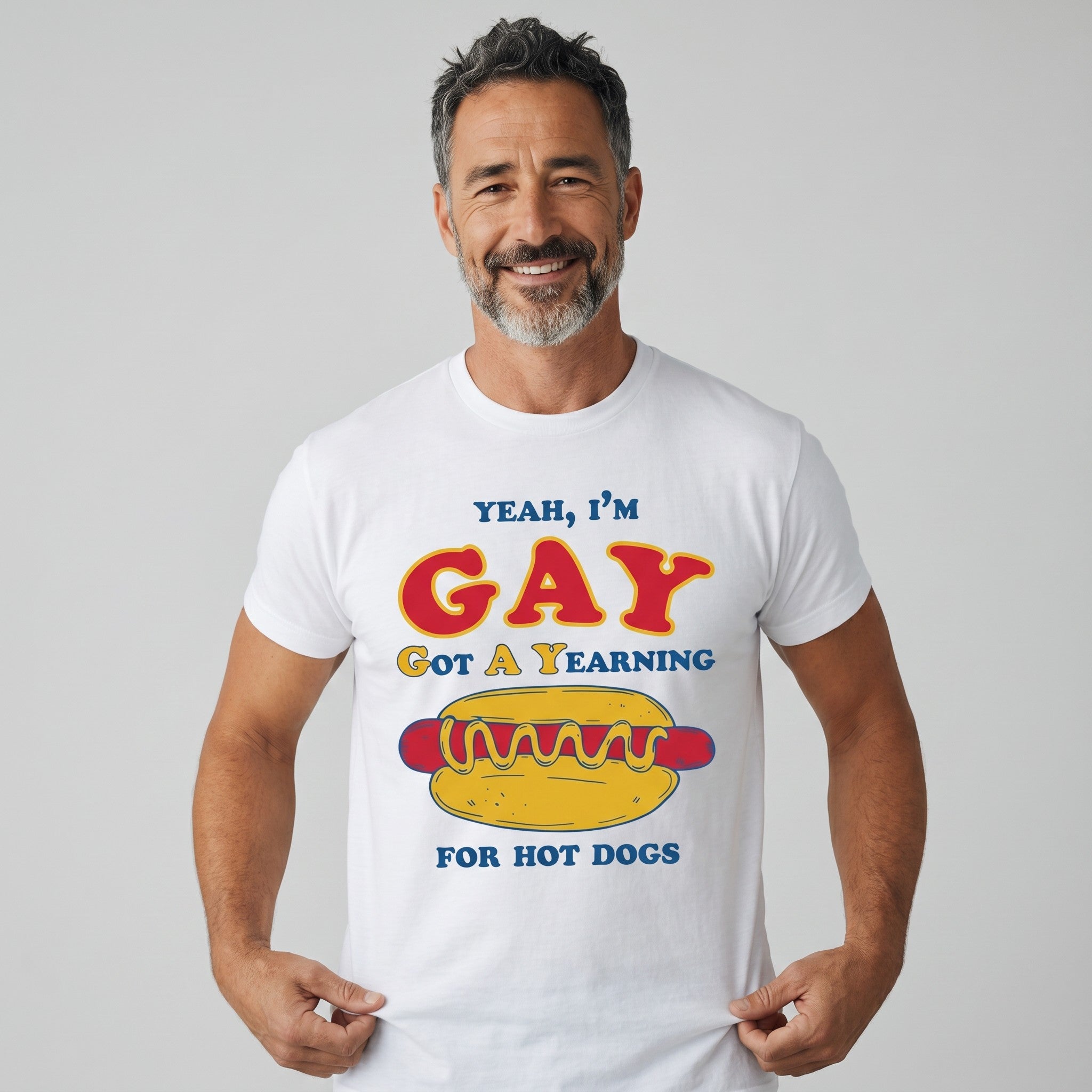 TrendyShift.Com white cotton t-shirt with Yeah I'm GAY Got A Yearning for HOT DOGS graphic print on a smiling man